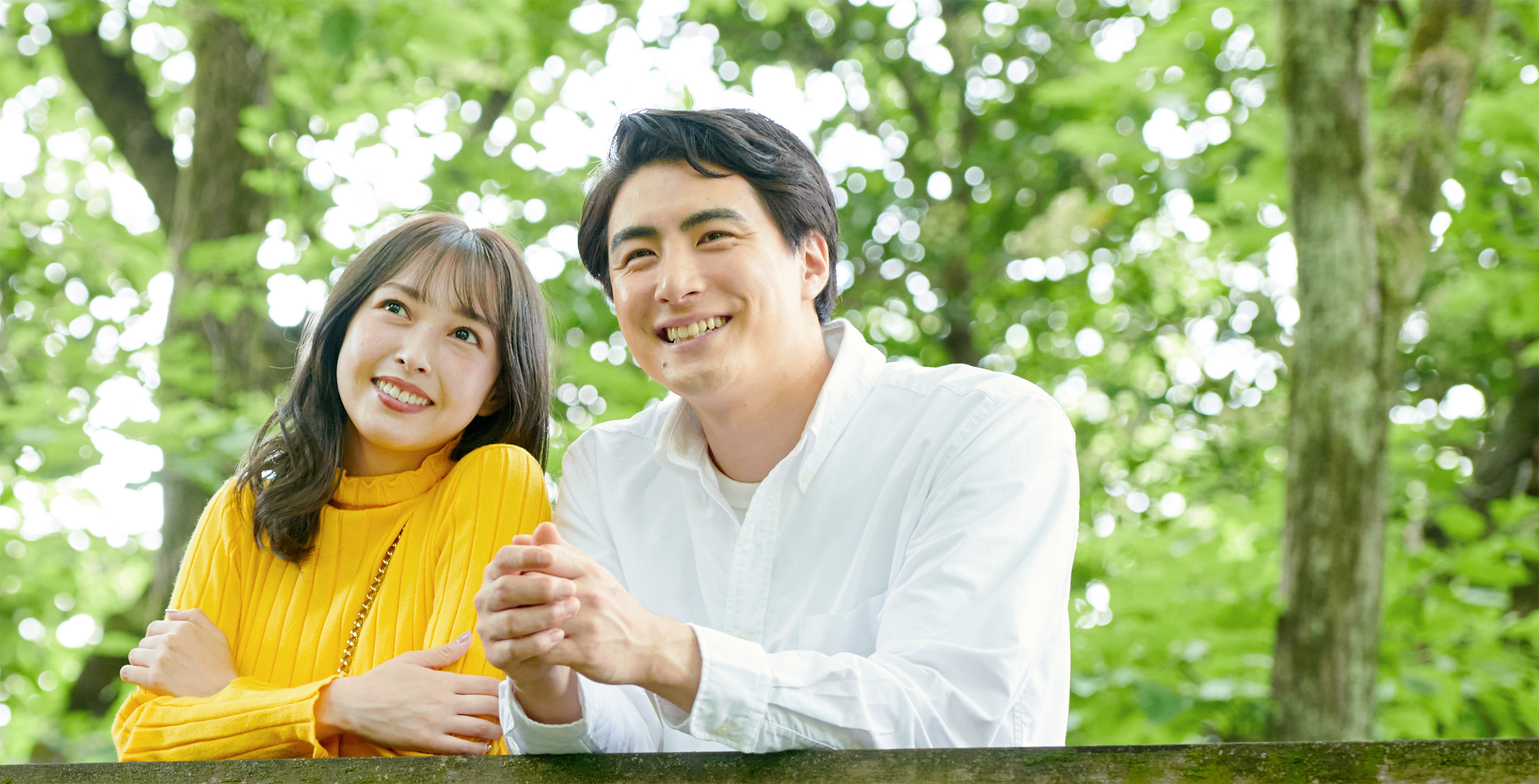 男女が同じ方向に見ている画像